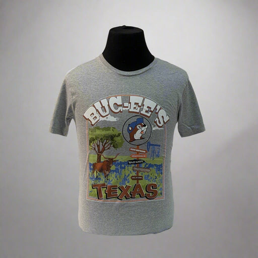 Show off your Lone Star pride with the Buc-ee’s Texas Signpost Shirt. This heather gray tee features a colorful, hand-painted style graphic of a Texas landscape — complete with a signpost pointing to iconic Texas spots, a longhorn, bluebonnets, and of course, the one and only Buc-ee’s beaver.

