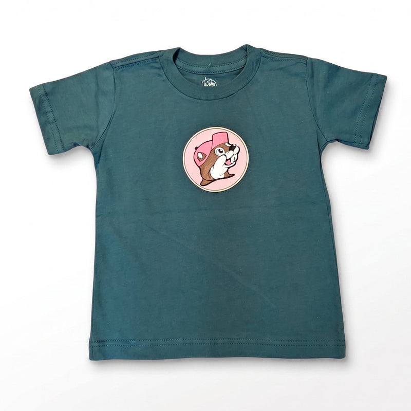 A dark teal green short-sleeve kids' t-shirt with a circular graphic of a cartoon dog wearing a pink hat on the chest, displayed flat against a white background.