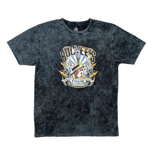 Front view of a Buc-ee's Tour Tee 2026,  a black mineral-wash t-shirt featuring a large, vibrant rock-and-roll graphic. In the center, the Buc-ee’s beaver wears a stylish black fedora, surrounded by electric guitars, radiant white wings, golden lightning bolts, and vintage-style speakers. A ribbon banner at the bottom reads "ROAD TOUR 2026" and "ROCKIN' SINCE '82," all set against a blue and yellow sunburst background.