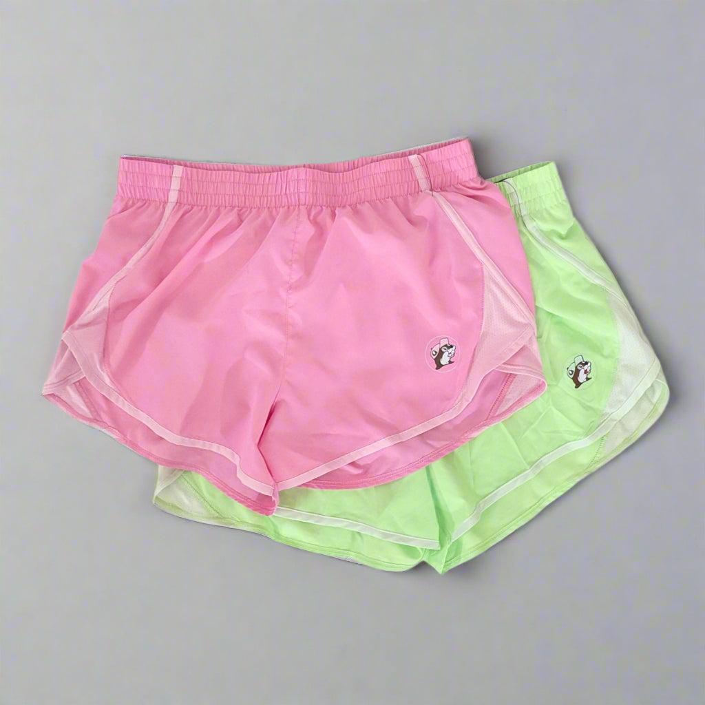 Buc-ee's Track shorts. Pink and green colors with the logo on the bottom corner of each. 