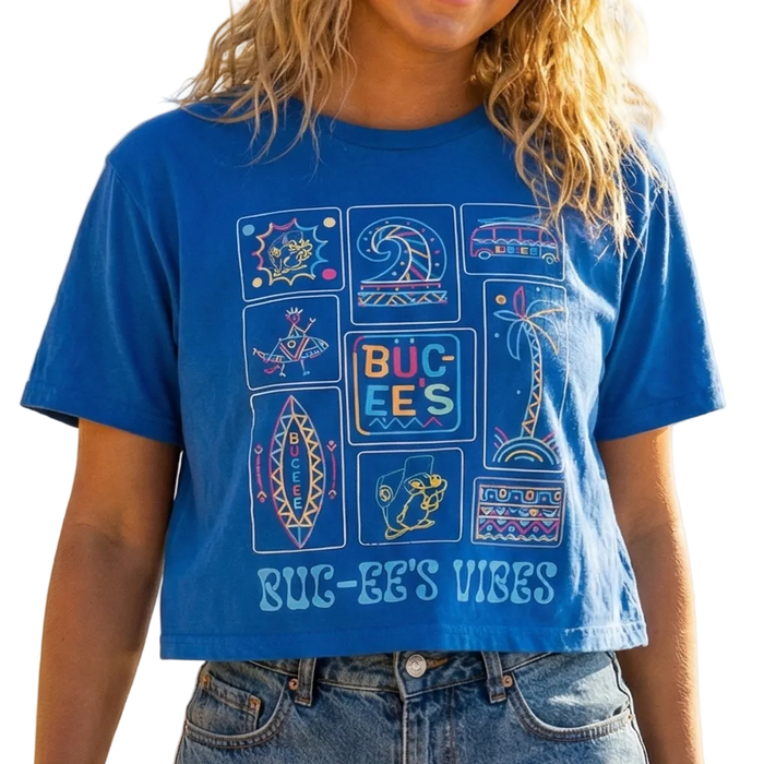 Woman wearing a blue graphic t-shirt on a beach