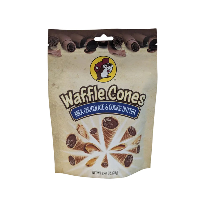 A photo of a sealed, stand-up pouch of Buc-ee's Waffle Cones snack. The bag is centered against a clean, white background. The packaging features the circular yellow Buc-ee's beaver logo at the top, bold text reading "Waffle Cones", and a blue banner indicating the flavor "Milk Chocolate & Cookie Butter". The lower half of the bag displays an illustrated explosion of mini waffle cones filled with chocolate alongside swirls of cookie butter, with the net weight "2.47 OZ. (70g)" printed at the bottom.