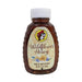 A 12 oz. plastic squeeze bottle of Buc-ee's Wildflower Honey standing upright against a white background. The container is a clear, amber-tinted bottle with distinct ribbed edges on the sides and a white plastic cap. The cream-colored label features a subtle honeycomb pattern, the round Buc-ee's beaver logo, cursive text reading "Wildflower Honey", an illustration of yellow and purple wildflowers, and the text "RAW & UNFILTERED" and "NET WT. 12 OZ. (340g)".