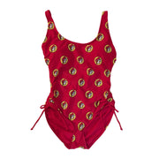 A Buc-ee's Red Logo women’s one-piece swimsuit featuring a scoop neckline and adjustable side-tie drawstrings at the hips to customize the leg height and fit. A vibrant, repeating pattern of the yellow and red Buc-ee’s beaver logo over the red swimsuit base. 