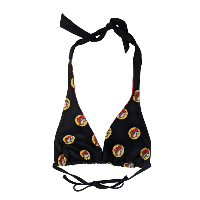 A Buc-ee's Women's Red Logo Reversible Bikini Top showing the black side. A triangle-style bikini top in black fabric with matching black halter neck and back ties. With a repeating pattern of the iconic yellow and red Buc-ee’s beaver logo. Swimsuit displayed on a clean white background.