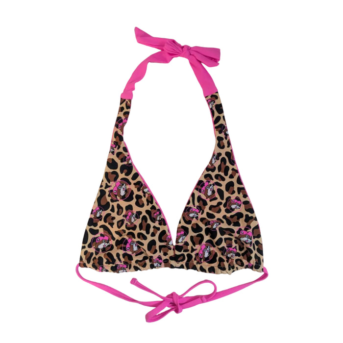 A Buc-ee's women's reversible bikini top showing the leopard print side. The halter-style top features a leopard print with pink Buc-ee's mascot icons and bright pink ties at the neck and back. The matching tie-side bottoms feature the same leopard print pattern with pink mascot icons and adjustable pink side ties, displayed on a clean white background.