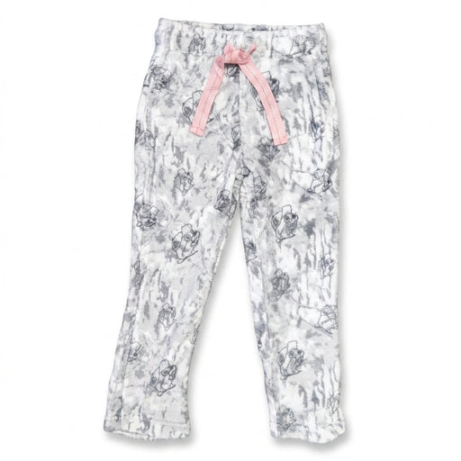 A front flat-lay photo of youth Buc-ee's plush sherpa lounge pants laid on a white background. The pants feature a light grey and white camouflage pattern patterned with Buc-ee's beaver mascot line drawings, an elastic waistband, and a contrast light pink drawstring tie.