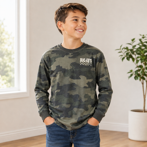 Youth boy wearing a green camouflage Buc-ee’s long-sleeve shirt with a white “BUC-EE’S” logo and stars, styled with blue jeans in a bright indoor setting.