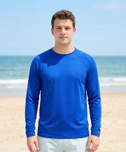 Man wearing a blue long-sleeve shirt on a beach