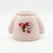 Pink sweatshirt-shaped planter with a cartoon design on a white background