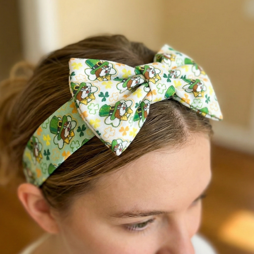 Person wearing a decorative headband with a floral pattern and shamrocks.