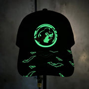 Glow in the Dark Neon Bat Trucker Hat in the dark against a wall.
