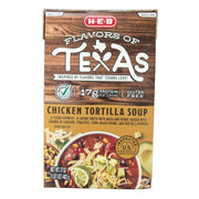 A front-facing carton of H-E-B "Flavors of Texas" Chicken Tortilla Soup against a clean white background. The top half of the carton features a rustic brown wood-grain texture with the "Flavors of Texas" logo. Key product callouts prominently displayed include "Select Ingredients," "17g Protein per serving," and "Gluten Free". The bottom gold-colored label describes the soup as a savory broth with masa and herbs, loaded with chunks of chicken, tomatoes, corn, black beans, and red bell peppers.