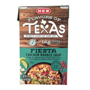 A 17-ounce carton of H-E-B "Flavors of Texas" Fiesta Chicken Noodle Soup. The packaging features a dark wood-grain top with a "14g Protein" label. The teal bottom section shows a serving suggestion of creamy, cheesy soup with noodles, chicken, and colorful peppers, garnished with lime and tortilla strips.
