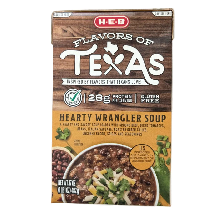 A 17-ounce carton of H-E-B "Flavors of Texas" Hearty Wrangler Soup. The wood-grain upper packaging highlights a "28g Protein per serving" callout and a "Gluten Free" badge. The bottom orange-gold label describes the soup as containing ground beef, Italian sausage, beans, and uncured bacon. A serving suggestion image shows a thick, meaty soup topped with shredded cheese and cilantro.