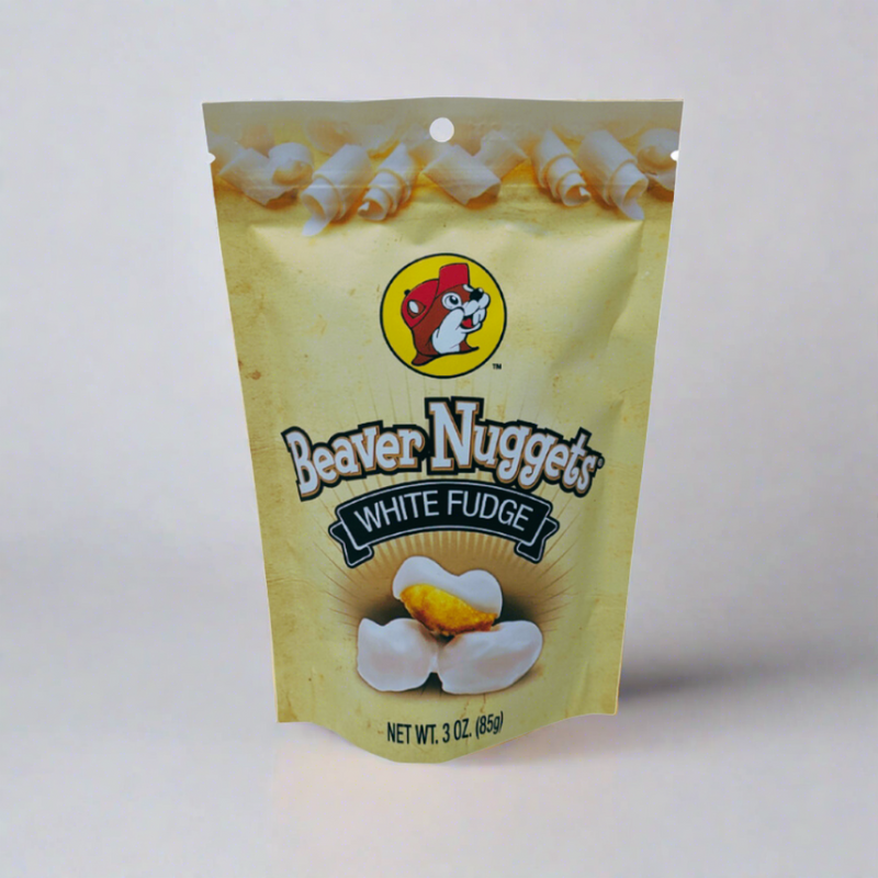 A sealed 3 oz yellow bag of Buc-ee's White Fudge Beaver Nuggets displaying the classic beaver mascot logo, as seen in the file image_5af89e.jpg.