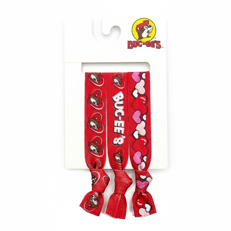 Red hair ties with heart designs on a Buc-ee's branded packaging.