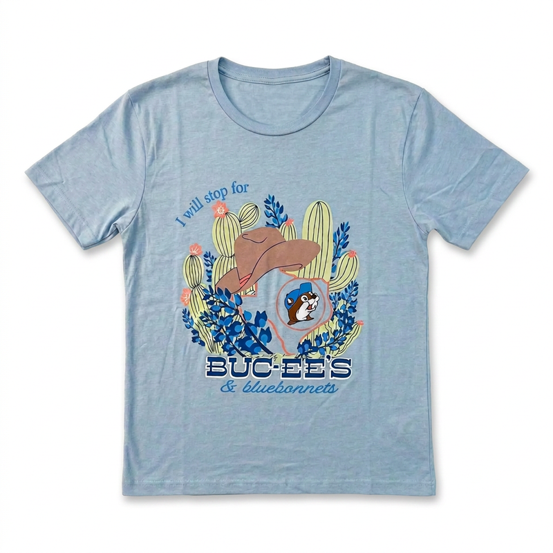 “I Will Stop For Buc-ee’s & Bluebonnets” shirt in light blue, front view with cacti, cowboy hat, and Texas outline