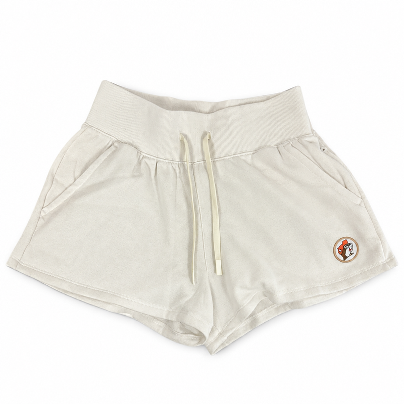 Buc-ee's Baja Fleece Shorts in cream with a wide ribbed waistband, drawstring, side pockets, and beaver logo patch