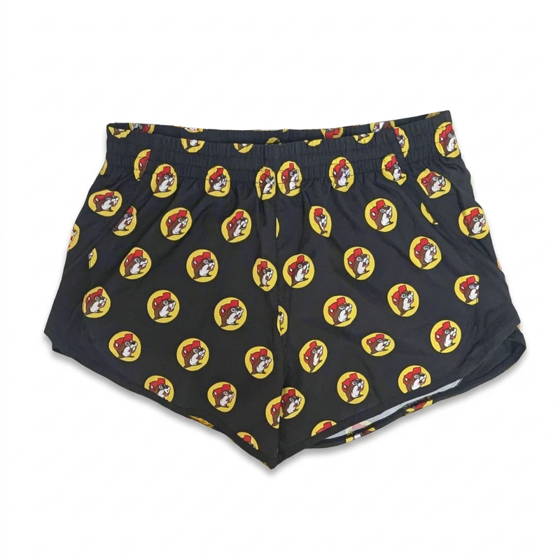 Buc-ee’s Black Logo Track Shorts with all-over yellow beaver logo print, elastic waistband, and curved split hem