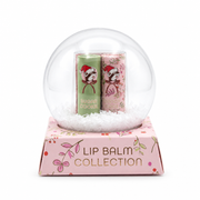 Buc-ee's Lip Balm Collection packaging styled like a clear snow globe on a pink floral base displaying "LIP BALM COLLECTION" with Sugar Cookie and Candy Cane lip balms inside.