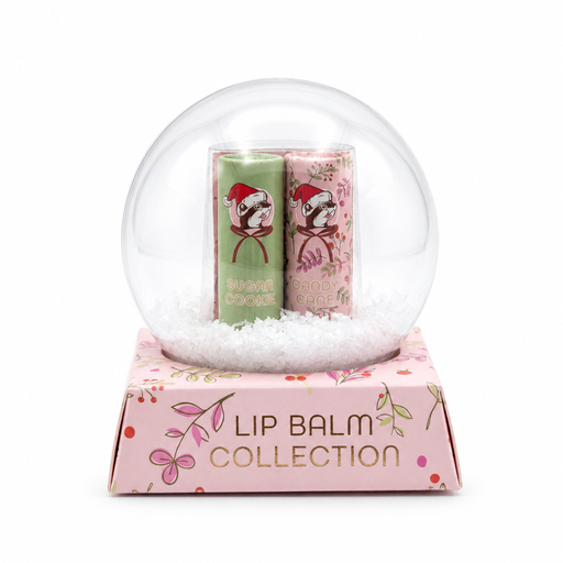 Buc-ee's Lip Balm Collection packaging styled like a clear snow globe on a pink floral base displaying "LIP BALM COLLECTION" with Sugar Cookie and Candy Cane lip balms inside.