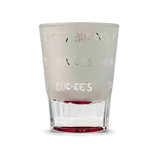Buc-ee's Royce City frosted shot glass with a repeating logo pattern, clear faceted base and red-tinted bottom, a Texas road trip souvenir