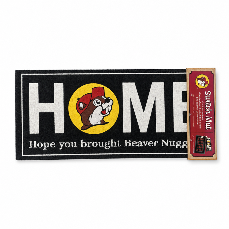 Buc-ee's black switch mat with "HOME" in white letters, the beaver logo as the O, and "Hope you brought Beaver Nuggets."