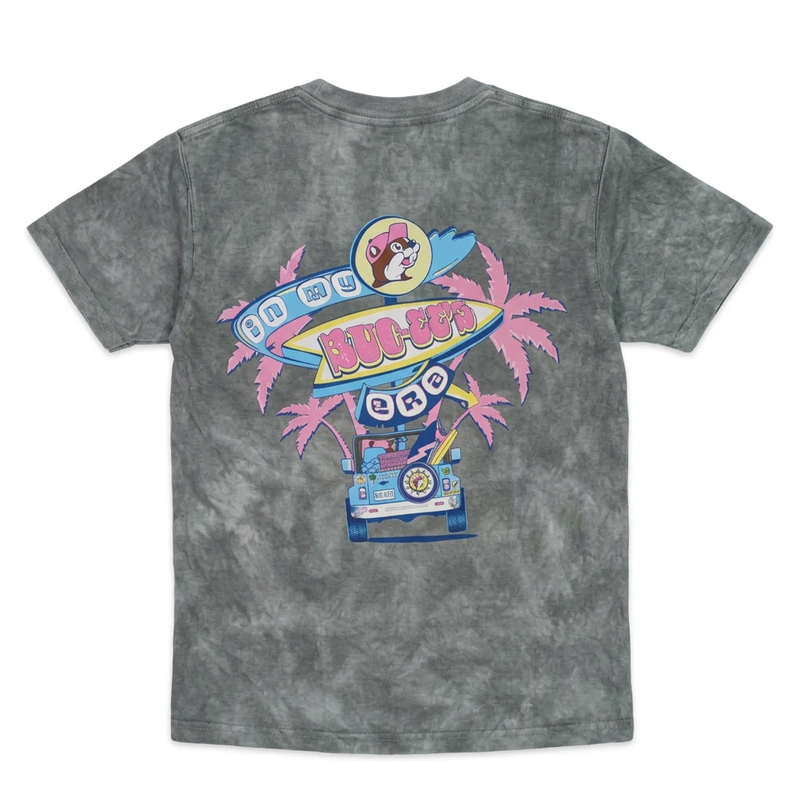 “In My Buc-ee’s Era” shirt in gray cloud wash, back view with retro surfboard sign, pink palm trees, and a blue SUV