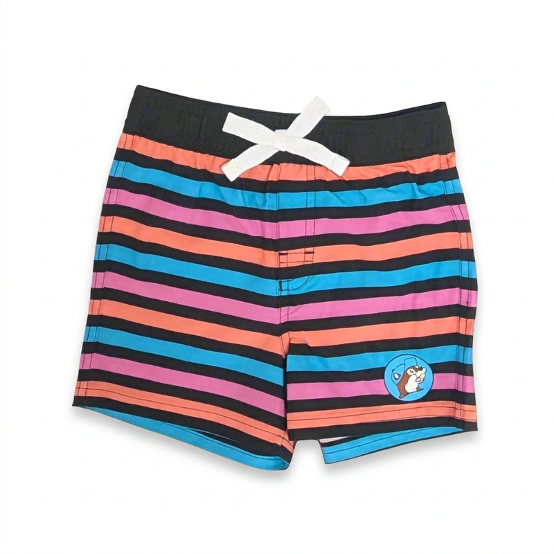 Buc-ee’s infant striped swim trunks in pink, coral, and turquoise with black waistband, white bow drawstring, and beaver patch