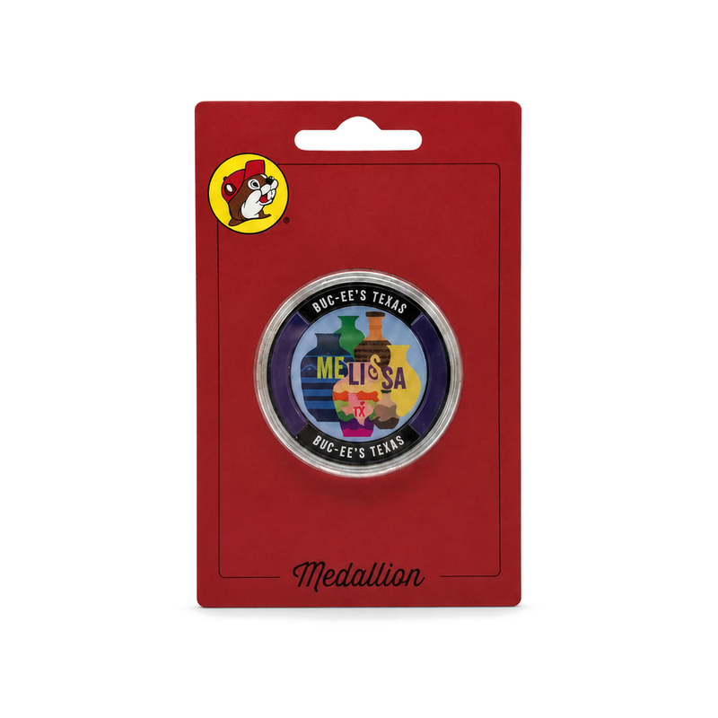 Buc-ee's Melissa, Texas collectible medallion with a colorful pottery vase design in a clear case on a red Medallion car