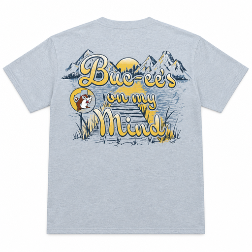 Buc-ee’s “On My Mind” shirt in heather gray, back view with yellow script over a mountain lake, dock, and sunset scene