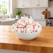 Buc-ee's Peppermint Saltwater Taffy piled in a white serving bowl on a butcher block kitchen counter