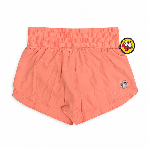 Buc-ee’s Performance Shorts in peach with smocked high-rise waistband, curved hem, and small beaver logo