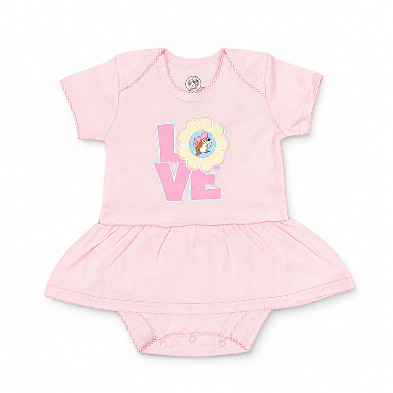 Buc-ee’s baby bodysuit dress in light pink with “LOVE” graphic, daisy beaver logo as the O, ruffled skirt, and snaps