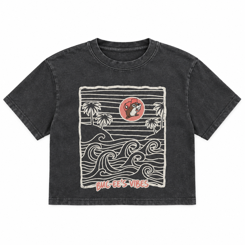 Buc-ee's Waves Crop Top, a washed charcoal crewneck with ocean waves, palm trees, and beaver logo sun graphic