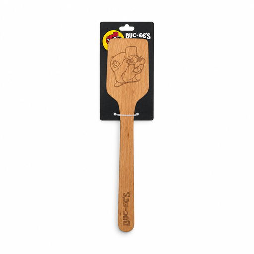 Buc-ee's wooden spatula with the beaver mascot engraved on the flat head and the logo on the handle, on a black hang card