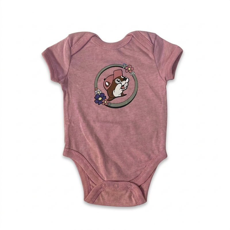 Buc-ee’s baby onesie in heather pink with the floral beaver logo, lap shoulder neckline, and snap bottom