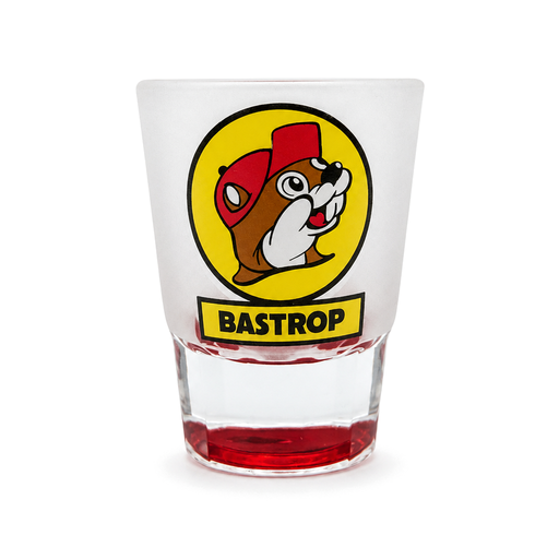 Frosted Buc-ee's Bastrop shot glass with yellow Buc-ee the Beaver logo and red base, on white