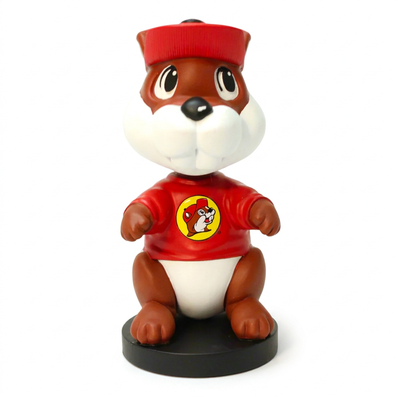 Front view of the Buc-ee’s beaver bobblehead showing its smiling face, buck teeth and the logo centered on its red shirt