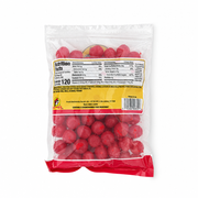 Back of Buc-ee's Cherry Sours bag showing nutrition facts, ingredients, and allergen info with red sour candy balls visible