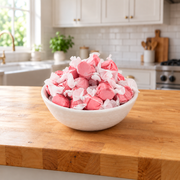 Buc-ee's Cinnamon Saltwater Taffy piled high in a white bowl on a butcher block kitchen counter, ready for sharing