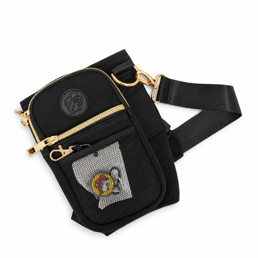 Buc-ee's Crossbody Tumbler Bag laid flat, showing the black strap, gold clips, and a beaver straw topper in the mesh pocket