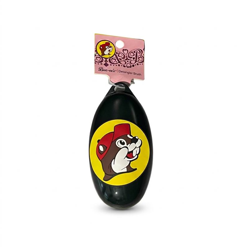 Buc-ee’s oval detangler brush in black with the classic beaver logo in a red cap on a yellow circle