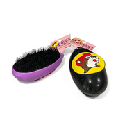 Buc-ee’s detangler brushes from the side, showing dense black bristles of mixed lengths and a handle-free palm shape