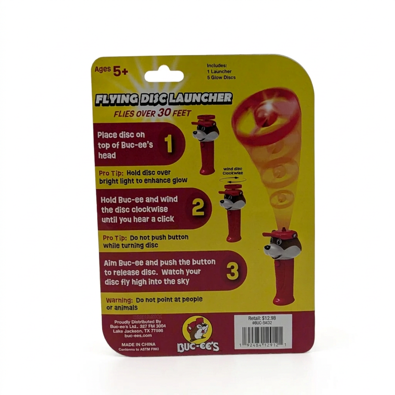 Buc-ee’s Flying Disc Launcher package back with 3-step wind-up instructions, a do-not-point warning, and contents list