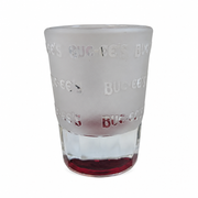 Buc-ee's Goodyear, AZ shot glass back view showing repeating clear brand-name lettering on frosted glass above faceted base