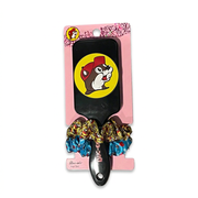 Buc-ee’s black hair set with a classic beaver logo paddle brush and two printed scrunchies in yellow and blue
