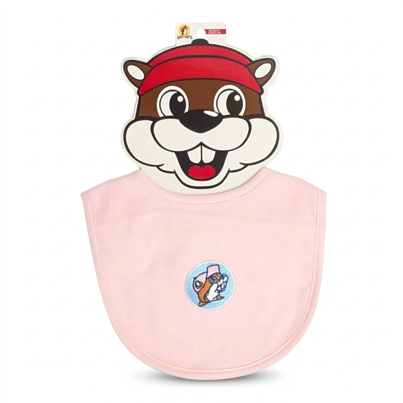 Buc-ee’s infant bib in solid pink with an embroidered pink-cap beaver patch on a blue circle, on a beaver-face card