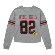 Buc-ee’s long sleeve raglan crop shirt in heather gray with a distressed red and black 82 jersey print and striped sleeves
